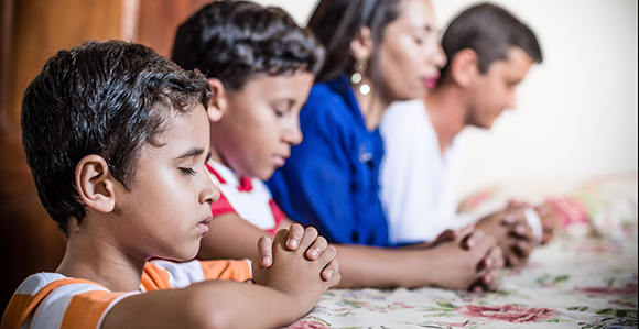 family praying in church