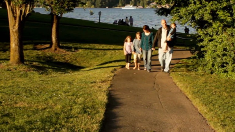 A family walk down a street enjoying the blessings of Jesus Christ