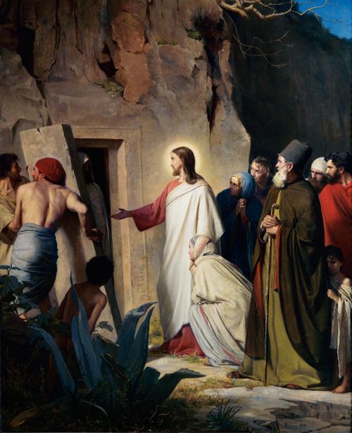 Christ at the tomb of Lazarus. He has His hand extended to the entry of the tomb as He commands Lazarus to rise from the dead. Lazarus (in burial robes) is visible standing inside the entry to the tomb. A man is moving the stone door of the tomb away from the tomb entry. Several people (men and women) are watching the miracle in amazement.