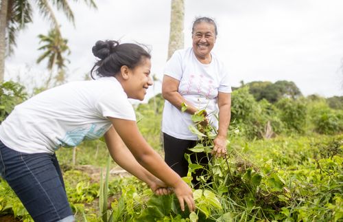 mother and daughter working on crops