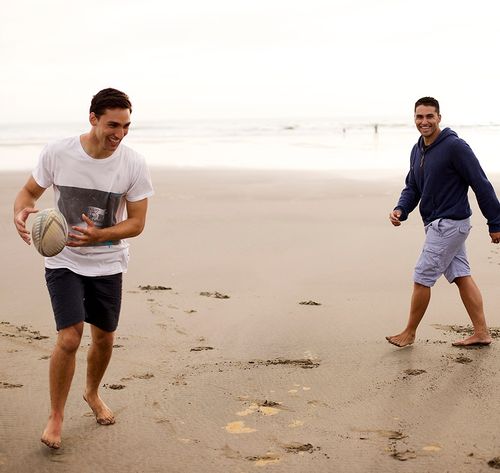 man playing with ball on beach