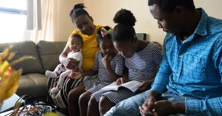 a family studies the scriptures together