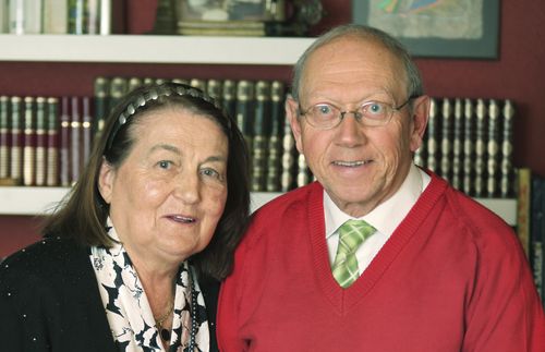 photo of a couple in front of a bookcase