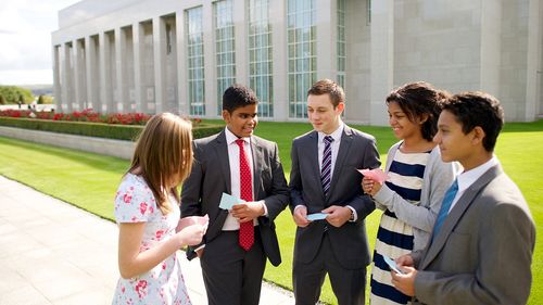 youth holding recommends outside temple