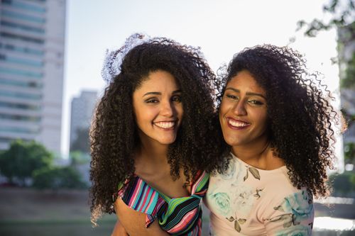 Adult sisters smiling