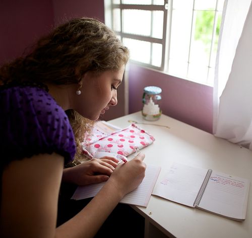 woman writing in planner