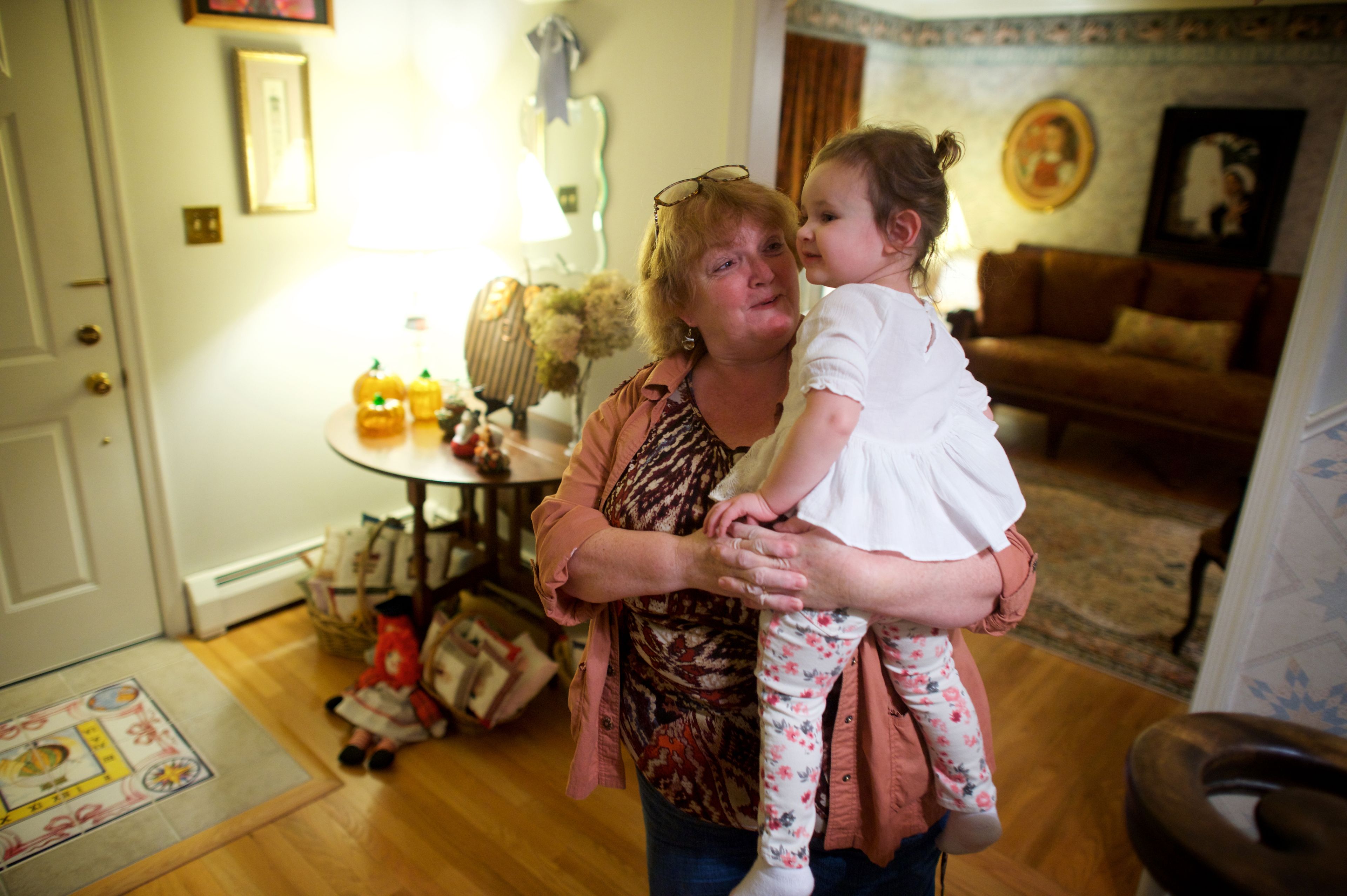 A woman in Pennsylvania stands and holds her young granddaughter.