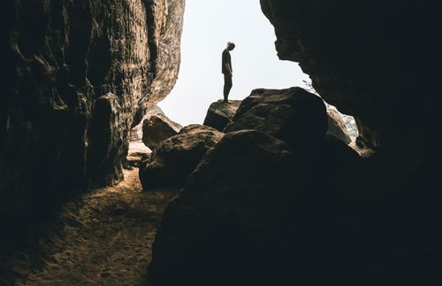 figure standing on a rock formation