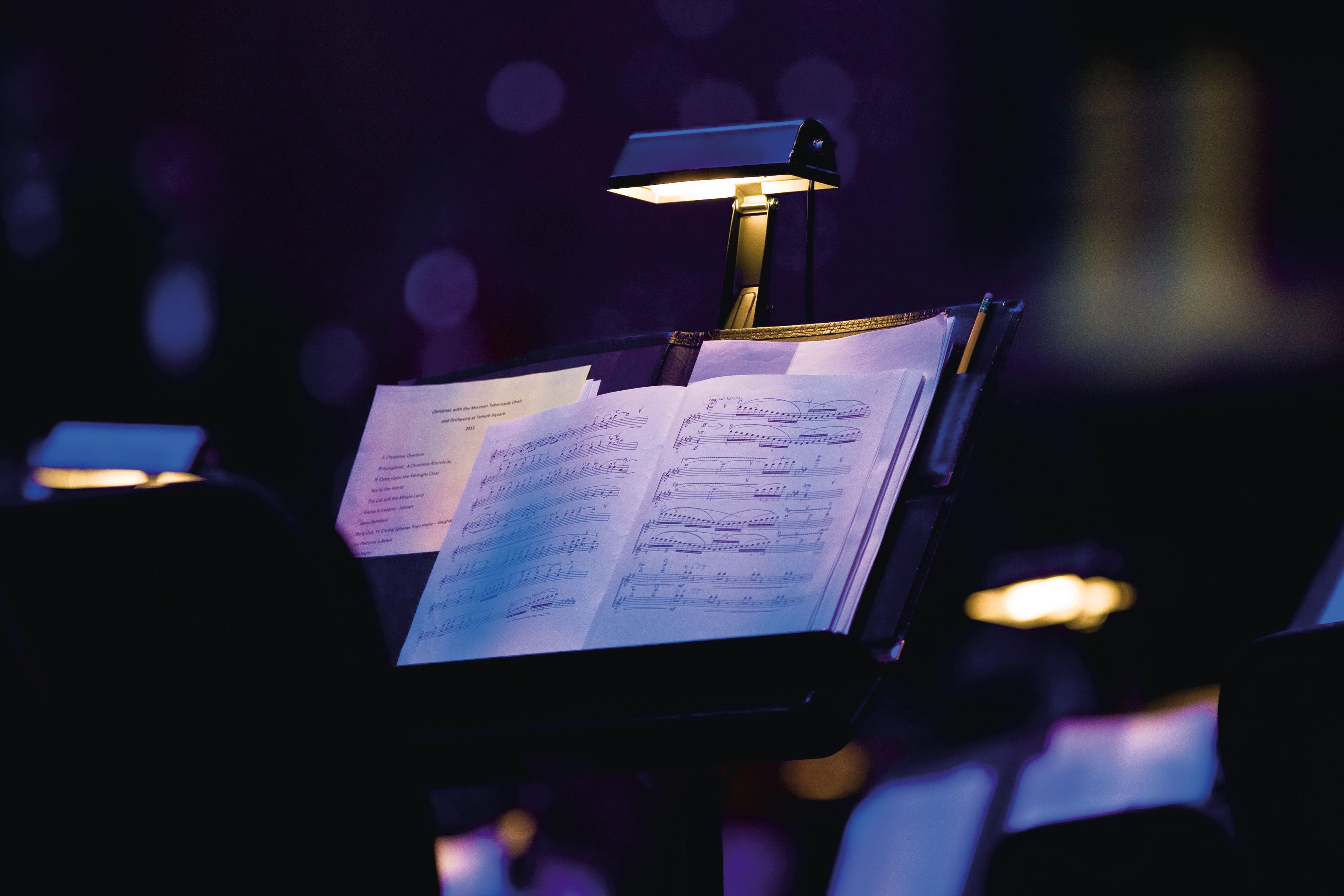 Sheet music sits on a music stand for a performer to read from.
