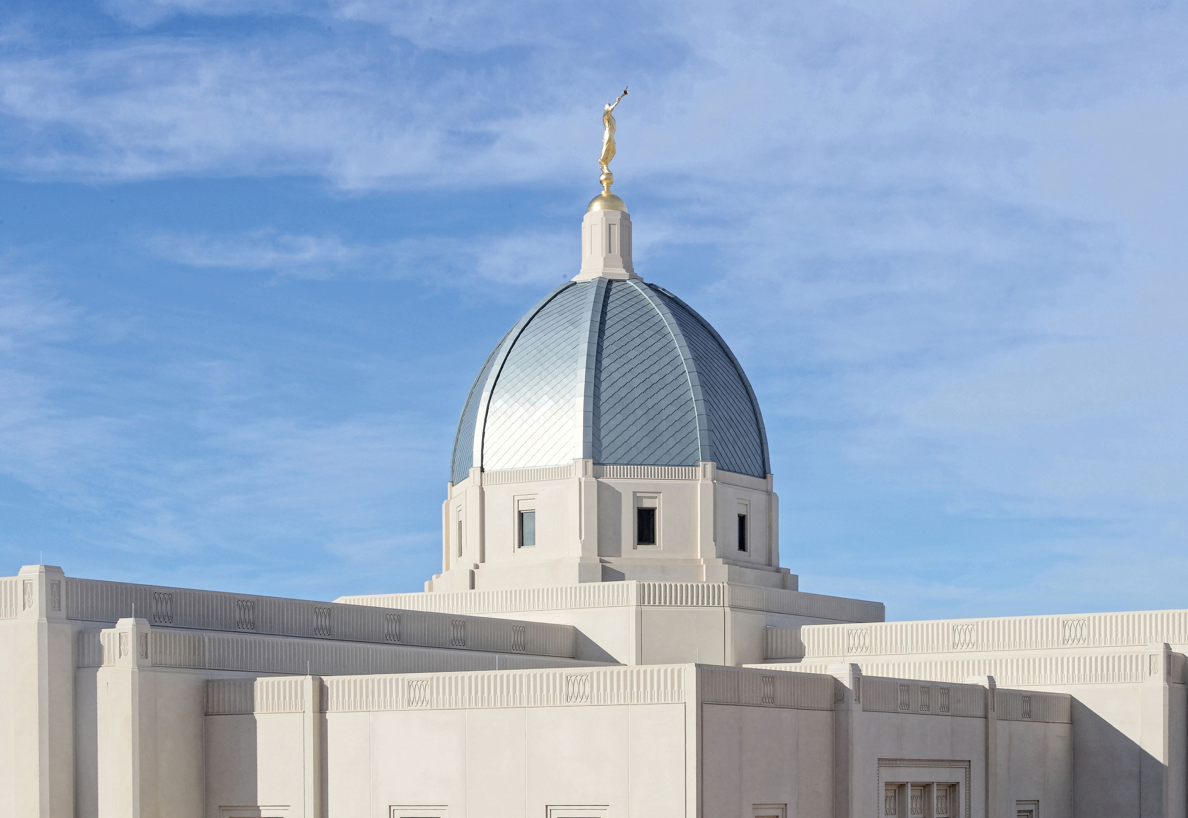 A photograph of the top of the Tucson Arizona Temple against a blue sky.