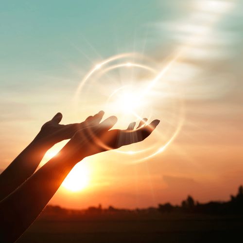 hands silhouetted against sunlight