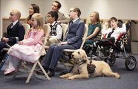 Children attend primary. One has a service dog and another is in a wheelchair.