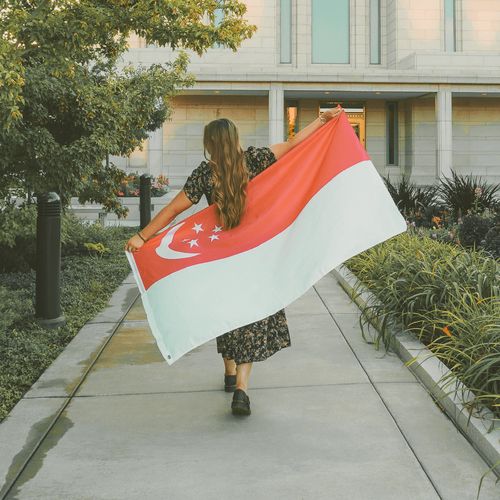 young woman with flag of Singapore