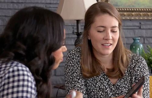 two women looking at a phone