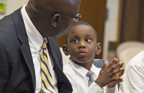 father and son sitting in church