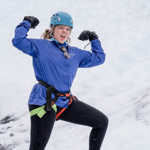 young woman climbing a mountain