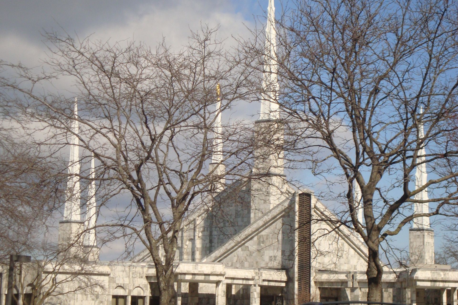 The six spires of the Chicago Illinois Temple show through the branches of the trees during the winter season.