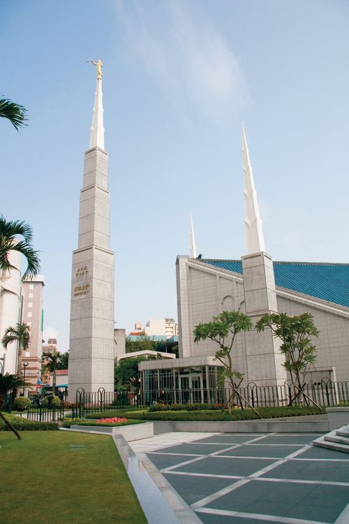 A daytime image of the Taipei Taiwan Temple, with a view of the entrance and two spires and a partial view of the grounds.
