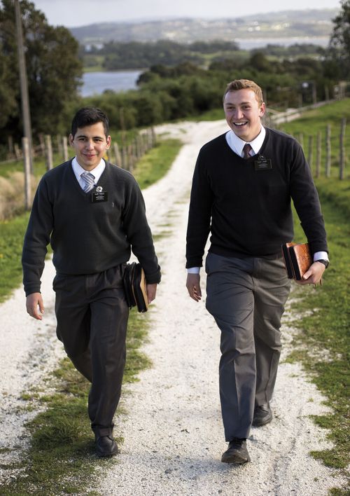 Two elder missionaries walking along a dirt road.