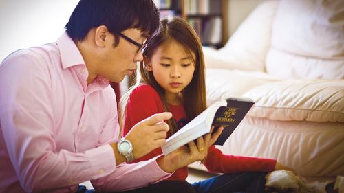 dad and daughter studying scriptures