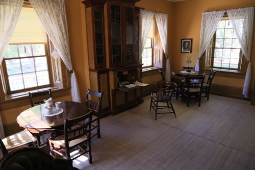 A large room with two tables surrounded by chairs inside the lower level of the Brigham Young winter home in St. George, Utah.