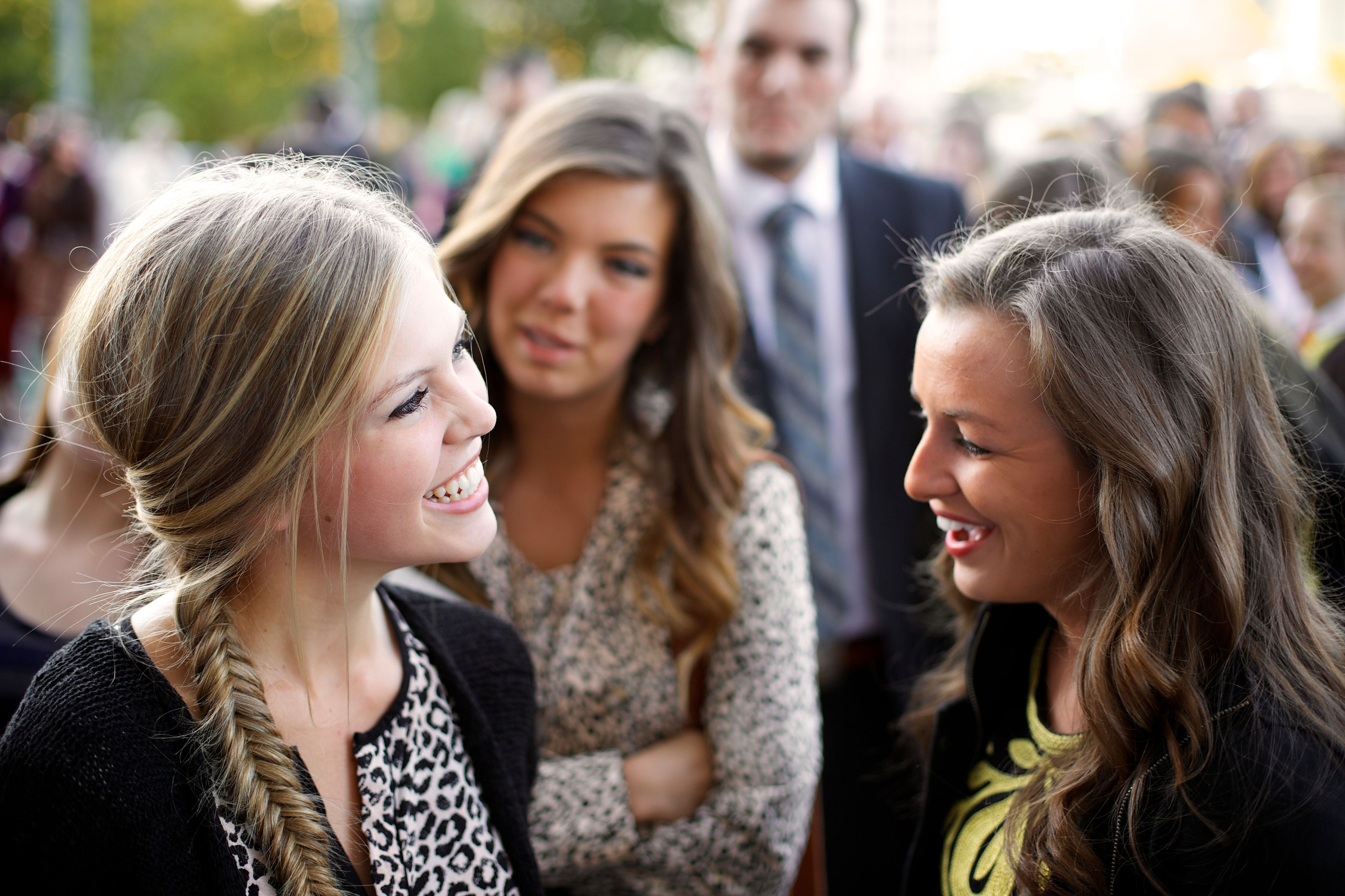 Three women standing and talking at general conference.