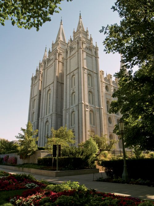 The back of the Salt Lake Temple, with a view of three of the temple spires and the trees on the grounds of the temple.