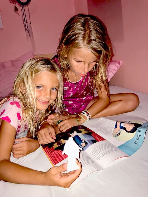 Two sister looking at the Friend magazine