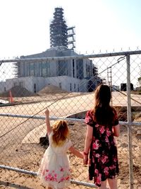 two girls watching temple being built