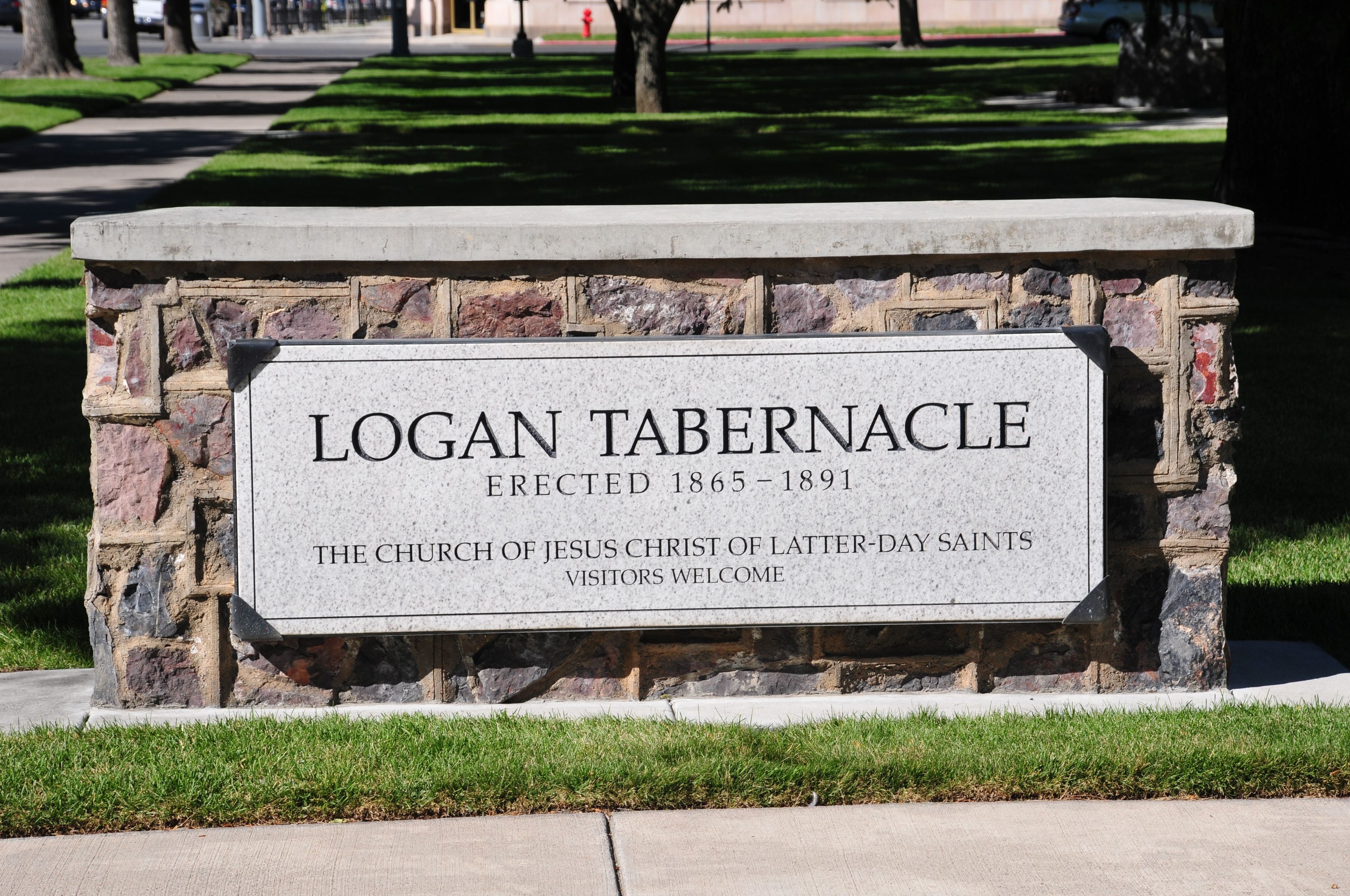 A sign surrounded by brick outside the Logan Tabernacle.