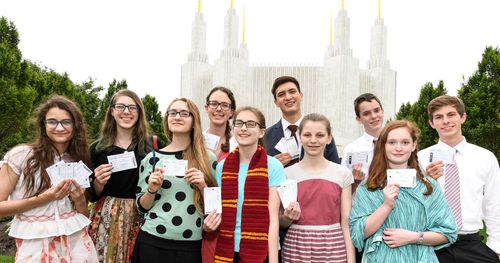 group of youth standing in front of temple