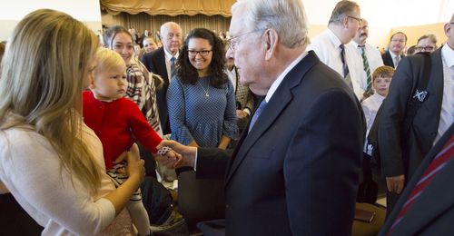 Elder M. Russell Ballard greeting members in Germany