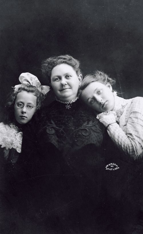 George Albert Smith’s wife, Lucy W. Smith, smiling between her two daughters, Edith (in glasses) and Emily (resting her head on her mother’s shoulder).