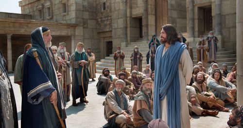 Jesus is shown with a group of people speaking to a scribe about the two great commandments. Outtakes: include close ups of people in the crowd. (Scene filmed at ext. the temple court of the Women)