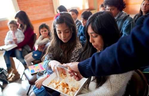 girl partaking of bread during sacrament meeting