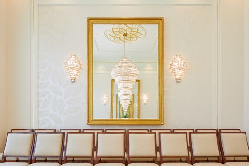 A mirror reflecting a chandelier and another mirror in a sealing room in the Port-au-Prince Haiti Temple.