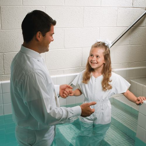 girl stepping into baptismal font