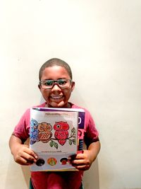 boy holding coloring page from Friend