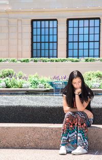 youth pondering outside temple