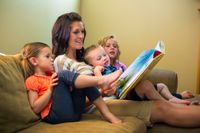 Mother reading with her children.