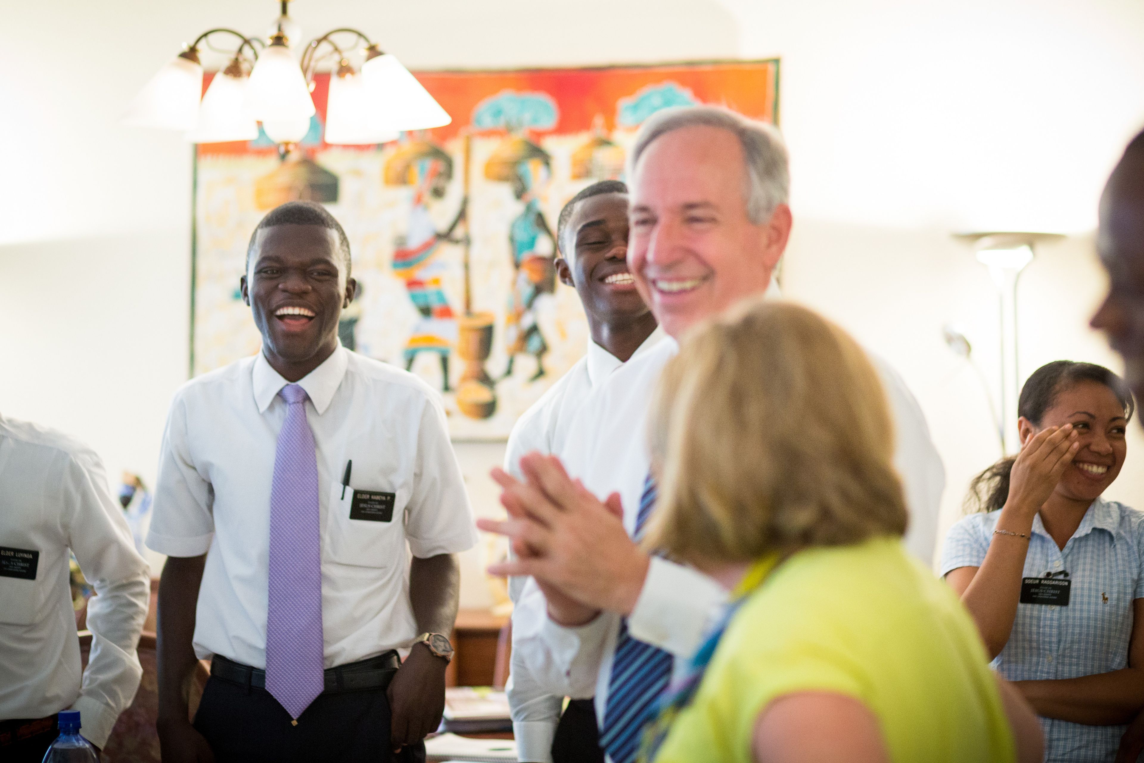 Missionaries laugh as a senior missionary couple teaches them.