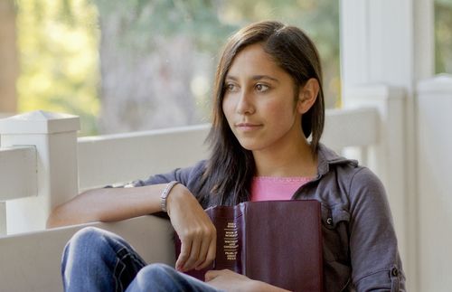 young woman holding scriptures