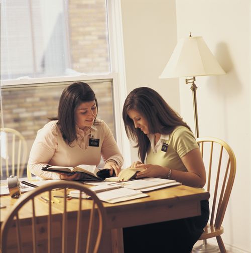 Two sister missionaries stuying the scriptures