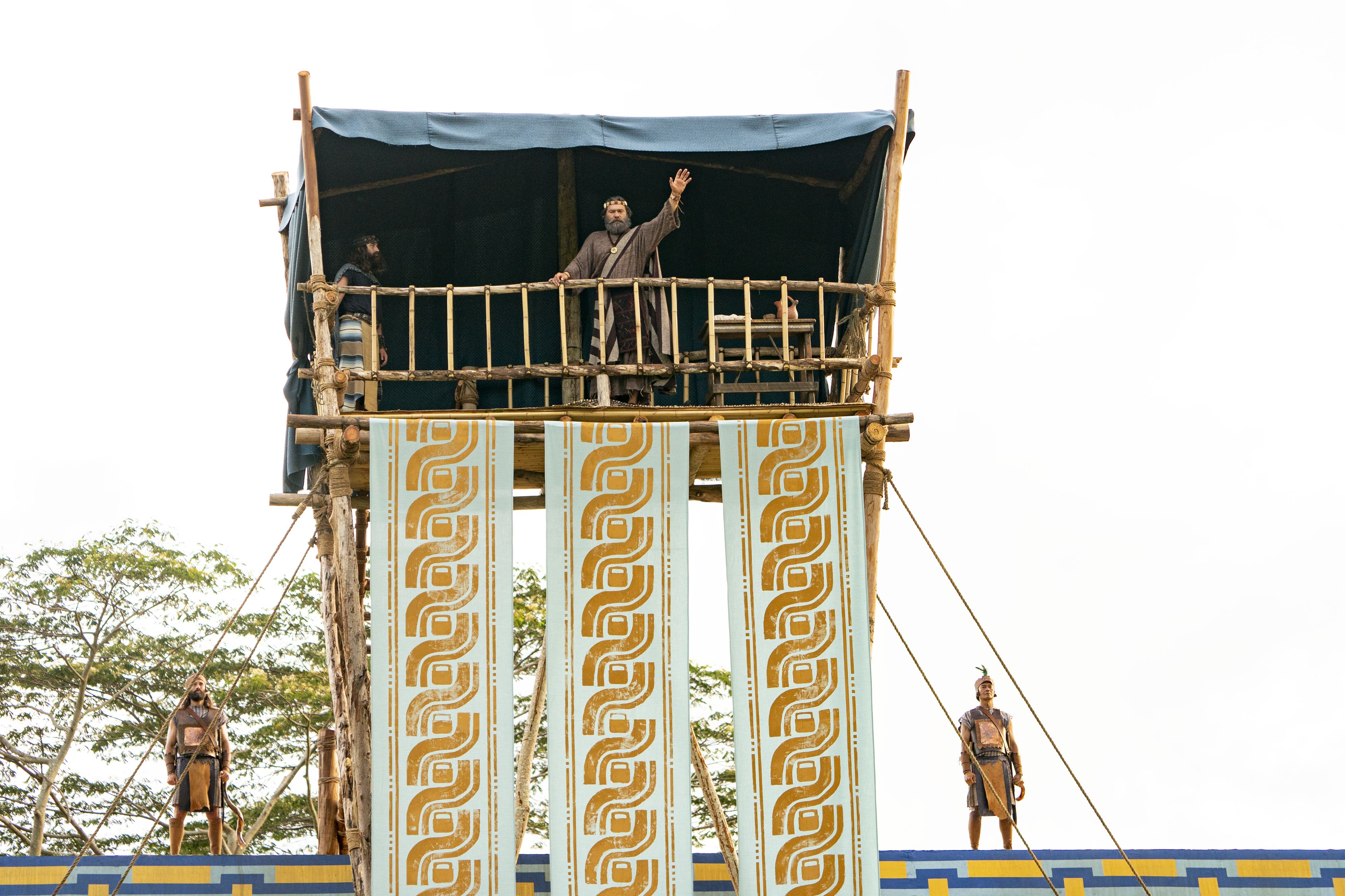 King Benjamin stands on a tower speaking to the Nephites in the Land of Zarahemla.