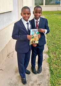 two boys holding copy of the Friend