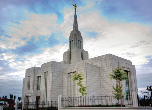 A front view of the Cebu City Philippines Temple, with a black iron fence surrounding the grounds.