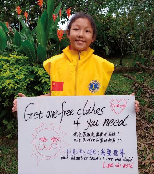photo of girl holding sign about free clothes