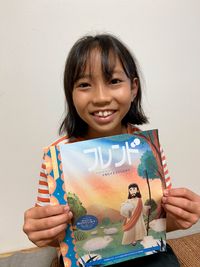 girl holding copy of Friend in Japanese