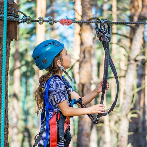 a young girl on a ropes course