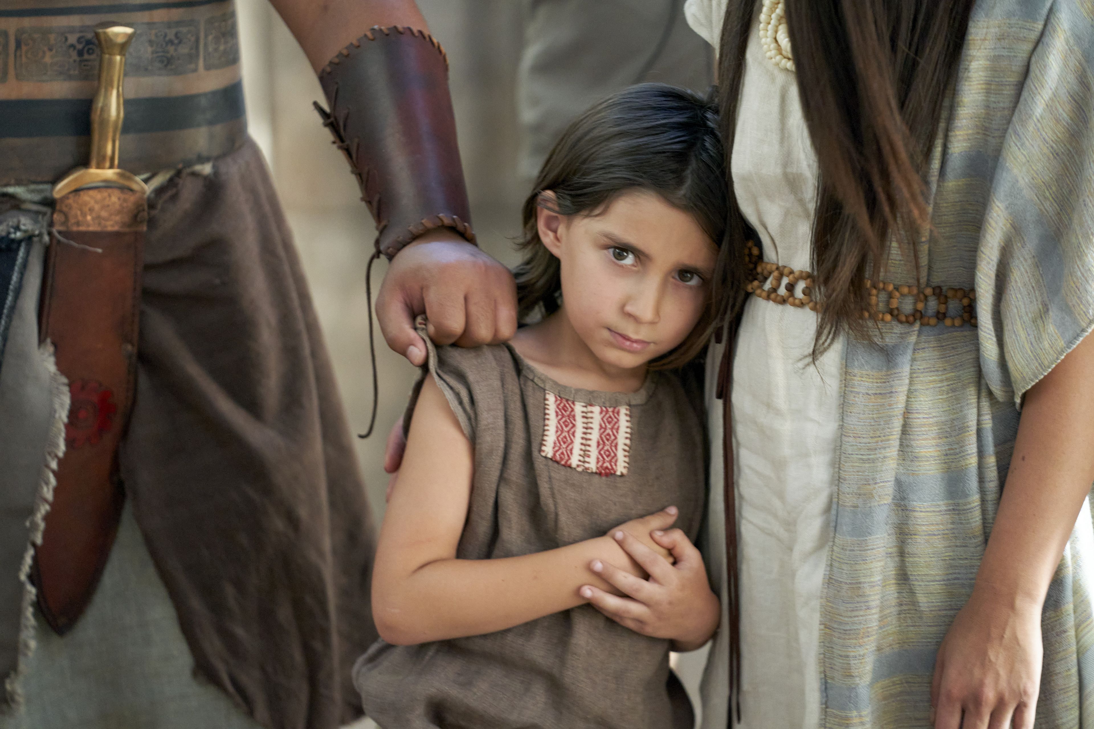 A young girl, believer in the words of Alma the Younger and Amulek, stands before a judge of Ammonihah.